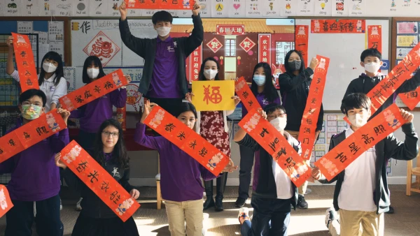 students making red new year banners inside yantai huasheng international school