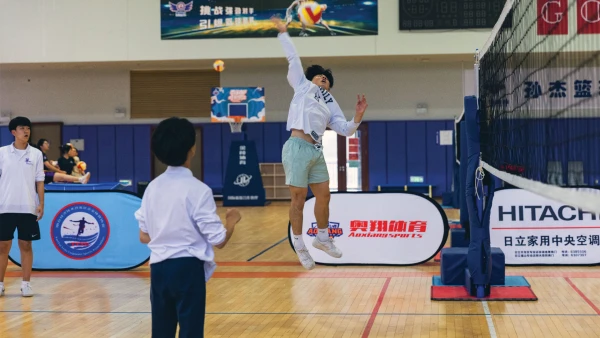 yantai huasheng international school high school male students playing volleyball in the gym