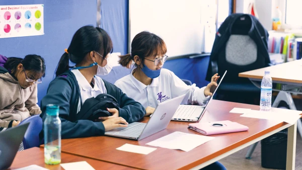 female students using laptop computers at yantai huasheng international school high school