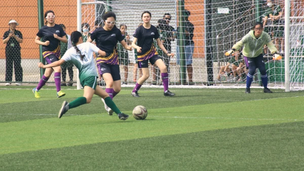female student soccer players at yantai huasheng international school about to defend a goal