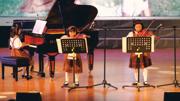 young female students at yantai huasheng international school about music on the violin