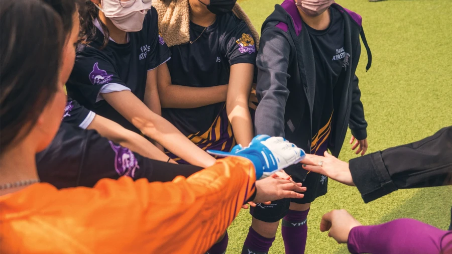 yantai huasheng international school high school students huddling during soccer game