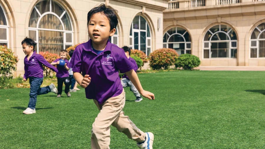 young male students playing outside at yantai huasheng international school